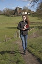 Young female vicar walking in her parish