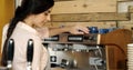 Female waitress cleaning coffeemaker in cafe 4k