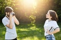 Young female wearing T-shirt and jeans posing in camera to photographer. Young talented male with retro camera photographing prett