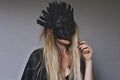 Young female wiccan witch wearing a Samhain hand made raven mask witch black feather crown Royalty Free Stock Photo