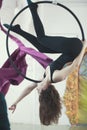 Young female woman hanging upside down on the aerial hoop Royalty Free Stock Photo