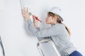 young female worker on white backgroun ladder Royalty Free Stock Photo
