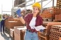 Young female worker who keeps records in a warehouse is calling for someone to help Royalty Free Stock Photo