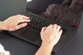 Young female working with laptop computer - detail on her hands over back keyboard Royalty Free Stock Photo