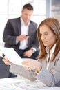 Young female working with papers in office