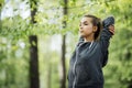 Young female workout at the park. Young woman is warming up and stretching her arms at outdoors on morning. Health care and sport Royalty Free Stock Photo