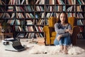 Young woman writer in library at home creative occupation sitting upset Royalty Free Stock Photo