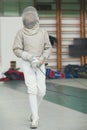 Young fencer in special costume at the fencing competition with rapier