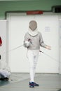 Young fencer in special costume at the fencing competition with rapier