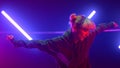 Woman dancing freestyle hip hop in neon lights. Blonde jumping in ultraviolet. Royalty Free Stock Photo