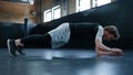 Young fighter making exercises in sport club. Sportsman doing push ups at gym