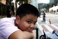 Young Filipino boy pose for the camera while at a business district Royalty Free Stock Photo