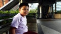 Young Filipino boy pose for the camera while at a business district