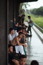 Manila, Philippines - MARCH 18, 2016: The young Filipino sits at a railway stop among the crowd and waits for the train