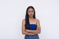 A young Filipino woman looking down, slightly disappointed. Expectations let down. Isolated on a white background