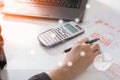 Young finance market analyst working at sunny office on laptop while sitting at white table.Businessman analyze document Royalty Free Stock Photo