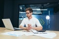 Young financier businessman working in modern office, man with laptop working with charts and diagrams paperwork