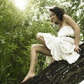 Young fine woman on tree