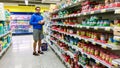 Young finnish man choosing baby food in a suomi supermarket S-Market, in Tampere Royalty Free Stock Photo