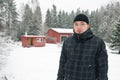 Young finnish man and traditional finnish cottage