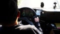 Young fireguard holds hands on steering wheel and controls a car riding to the place of fire. Fireman operating the fire