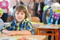 Young first grade student sitting at desk on his first day at sc