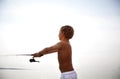 Young fisherman fishing at first light in the morning Royalty Free Stock Photo