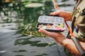 Young fisherman fishing on lake or river. Close up picture of guy holding some plastic artificial lures for catching Royalty Free Stock Photo