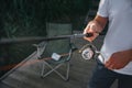 Young fisherman fishing on lake or river. Cut view and close up of reel and rod. Guy using fishing equipment for Royalty Free Stock Photo