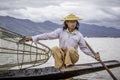 Fishermen with fish in Lake inle - traditional fishing on boat, Myanmar