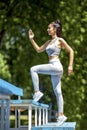 Young fit beautiful girl presenting running figure on a stairs Royalty Free Stock Photo