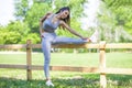 Young fit beautiful girl resting and stretching on a fence Royalty Free Stock Photo