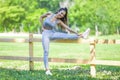 Young fit beautiful girl resting and stretching on a fence Royalty Free Stock Photo