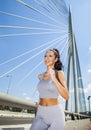 Young fit beautiful girl running outdoor on bridge Royalty Free Stock Photo