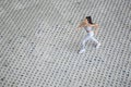 Young fit beautiful girl running outdoor on a pavement bricks Royalty Free Stock Photo