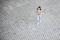 Young fit beautiful girl running outdoor on a pavement bricks Royalty Free Stock Photo