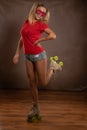 Young fit black woman on roller skates riding outdoors on urban street. Smiling girl with afro hairstyle rollerblading on sunny da Royalty Free Stock Photo