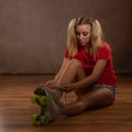 Young fit black woman on roller skates riding outdoors on urban street. Smiling girl with afro hairstyle rollerblading on sunny da Royalty Free Stock Photo