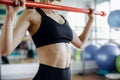 Young fit brunette girl doing exercise on the biceps with barbell. Crossfit, sports and health concepts Royalty Free Stock Photo