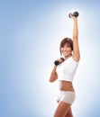 A young and fit brunette training with dumbbells Royalty Free Stock Photo