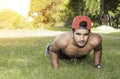 Young fit Caucasian man doing push-ups outdoors on sunny summer day. Fitness and sport lifestyle concept. Royalty Free Stock Photo