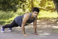 Young fit Caucasian man with muscular body doing push-ups outdoors on sunny summer day Royalty Free Stock Photo