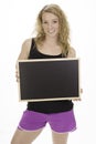 Young fit female holding blackboard