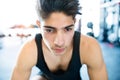 Young fit hispanic man in black sleeveless shirt in gym