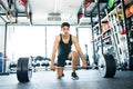 Young fit hispanic man in gym lifting heavy barbell Royalty Free Stock Photo