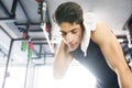 Young fit hispanic man in gym wiping sweat off his face Royalty Free Stock Photo