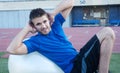 Young fit male athlete on workout ball Royalty Free Stock Photo