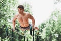 Young fit man doing push ups on bars Royalty Free Stock Photo