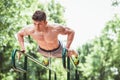 Young fit man doing push ups on bars Royalty Free Stock Photo