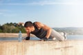 Young fit man doing push-ups outdoors on sunny summer day Royalty Free Stock Photo